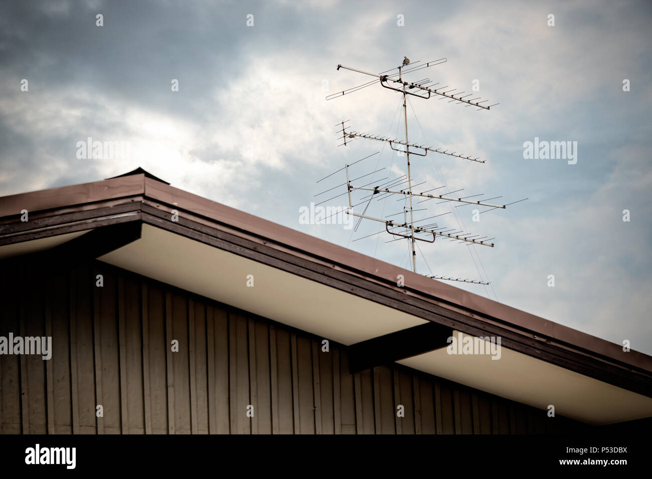 Close Up Classic Old Tv Antenna On House Roof Over Cloudy Sky Stock Photo Alamy