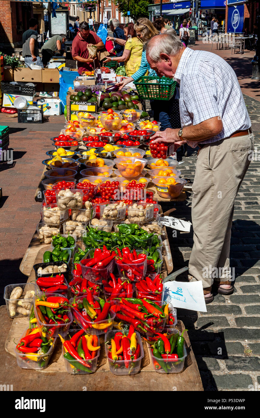 A Senior Man Buying Fruit and Vegetables From A Market Stall, Lewes, East Sussex, UK Stock Photo