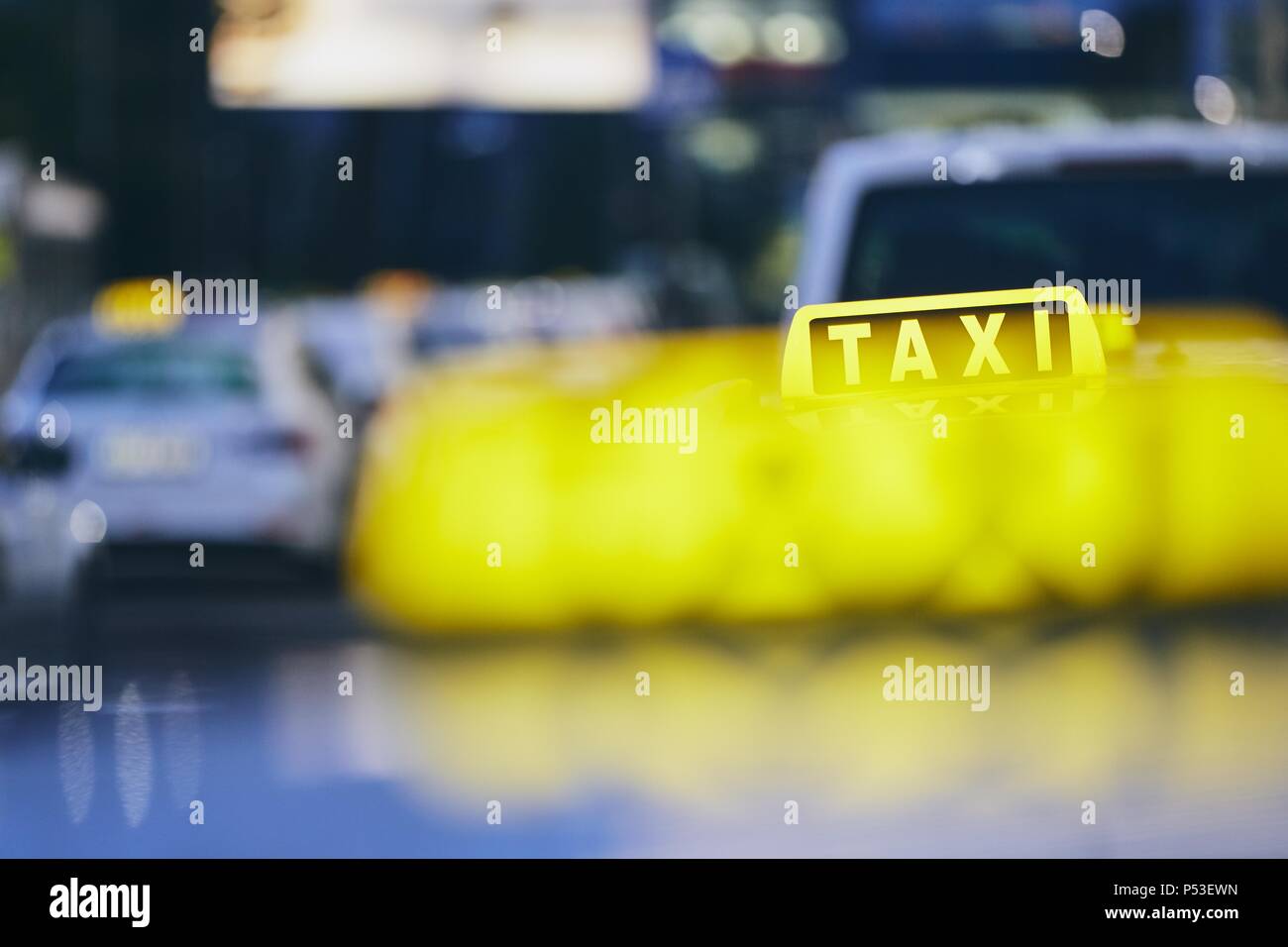 Lighting taxi sign. Cars against city street at night. Prague, Czech Republic. Stock Photo