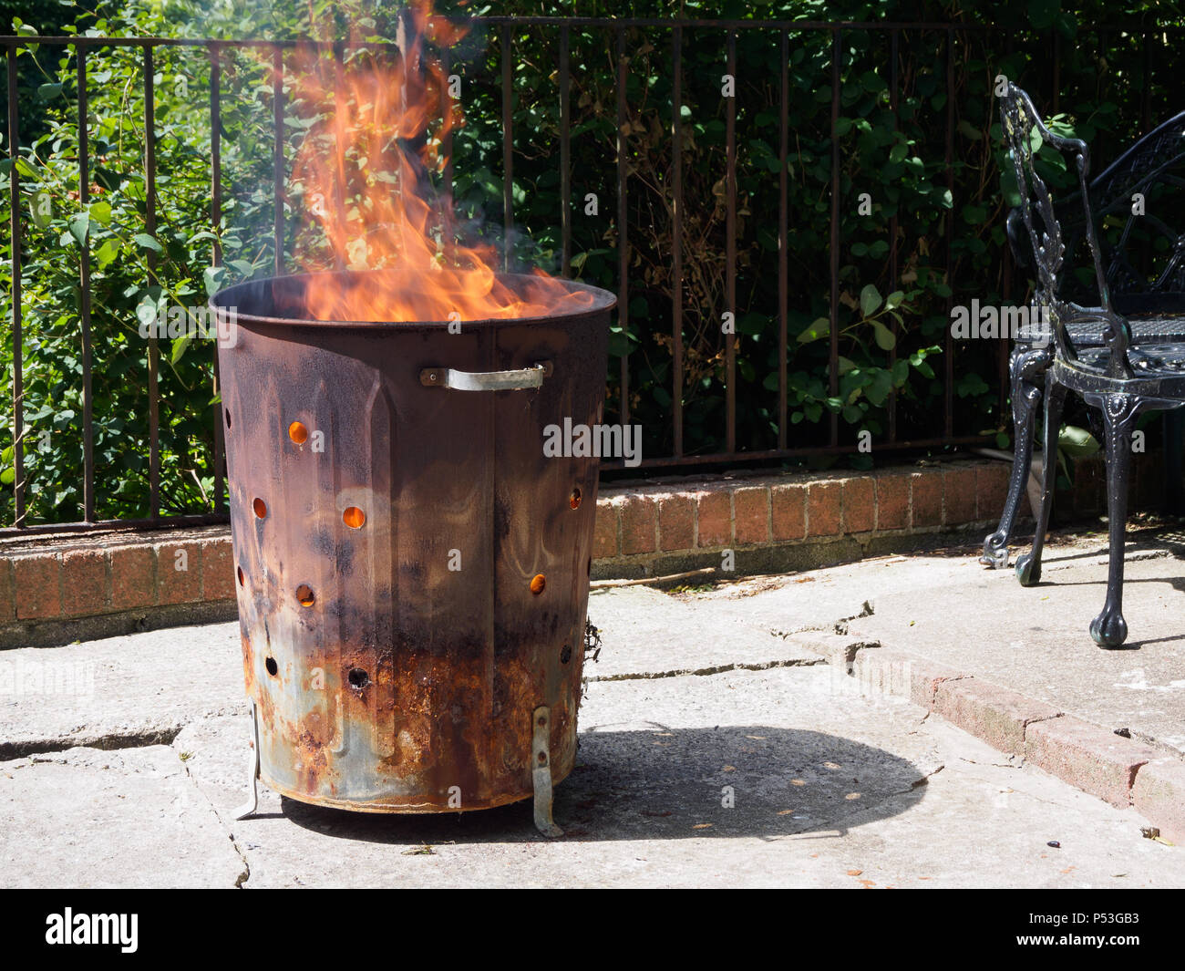 https://c8.alamy.com/comp/P53GB3/destruction-of-garbage-by-means-of-burning-in-a-garden-incinerator-bin-cause-smoke-which-air-pollution-not-helping-the-environment-P53GB3.jpg