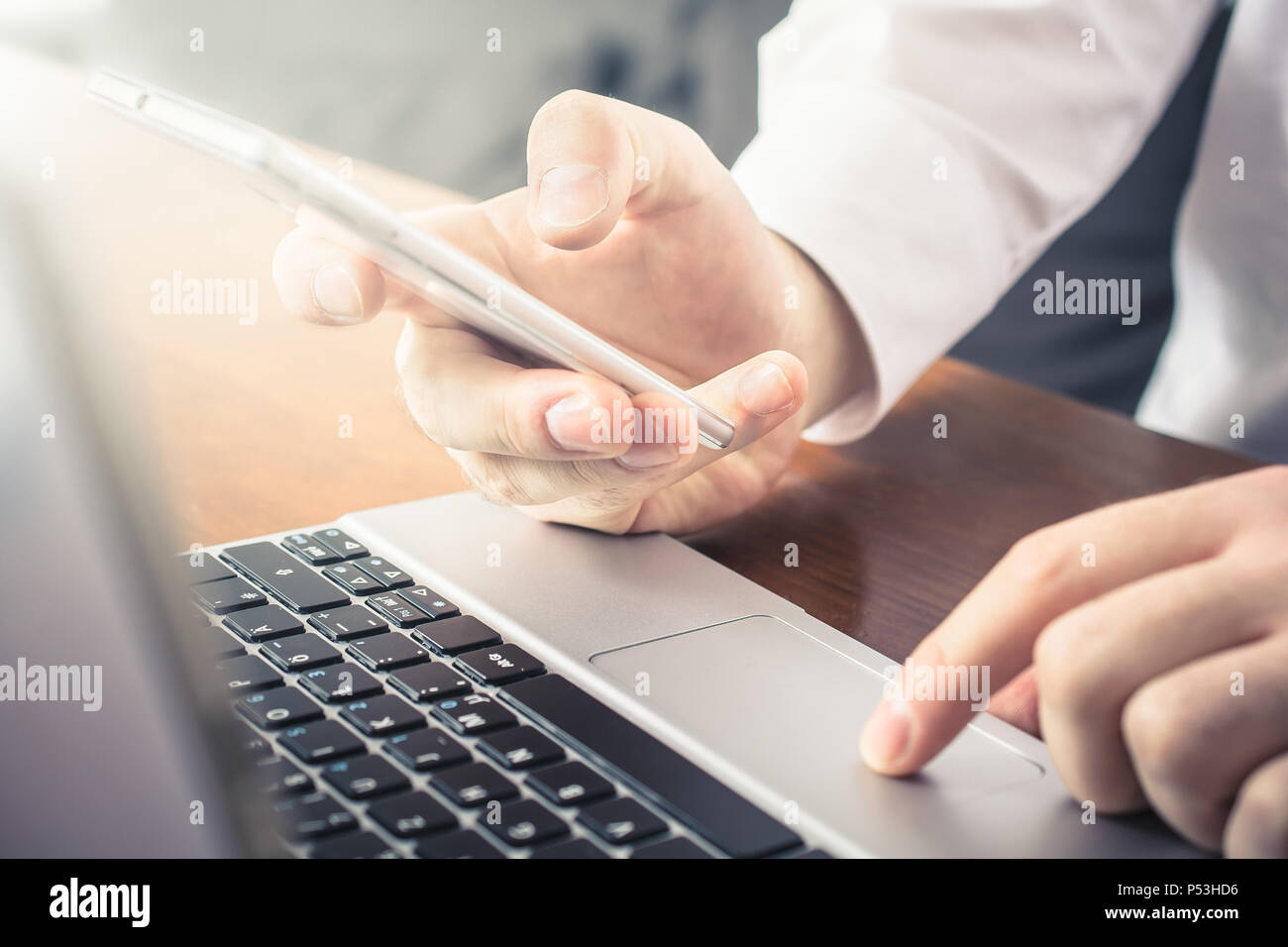 Businessman Working With Mobile And Notebook In Office Stock Photo