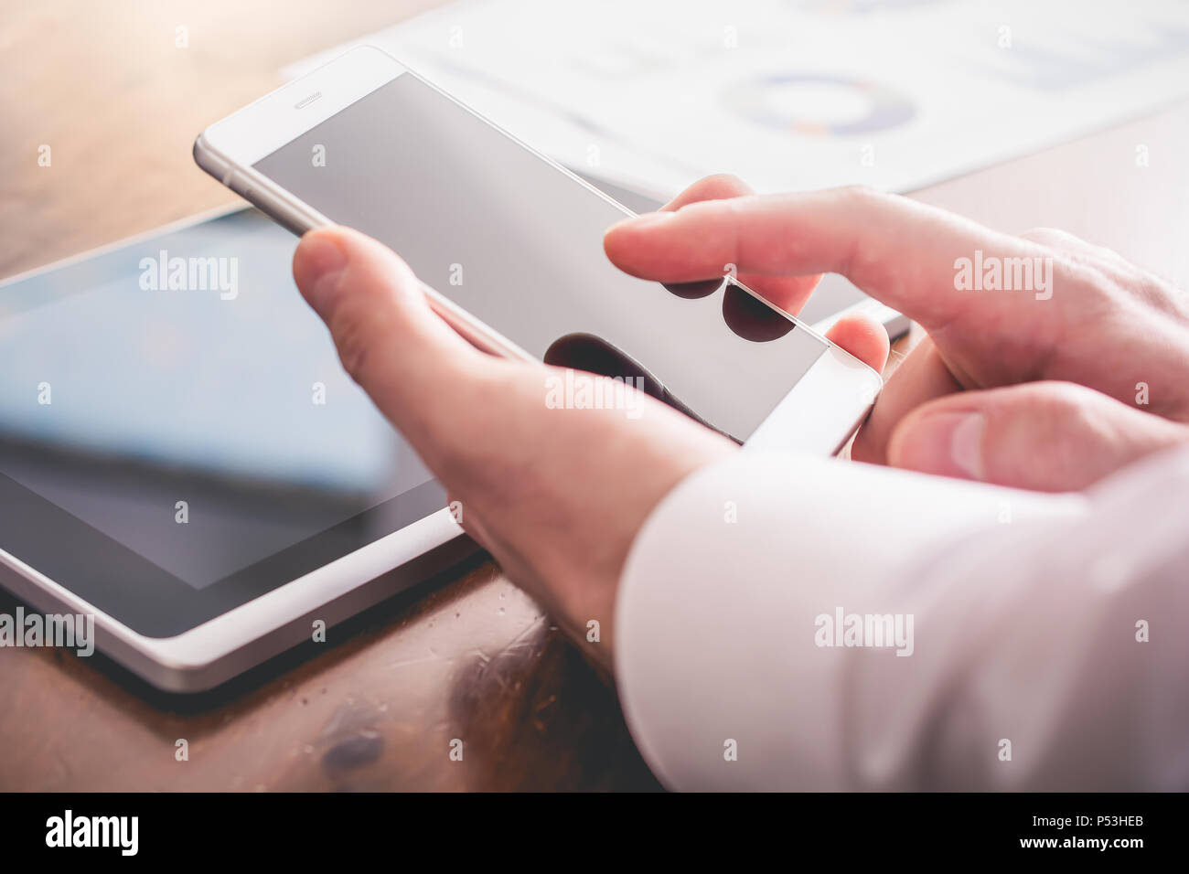 Businessman Analyzing Financial Statistics With Smartphone Stock Photo