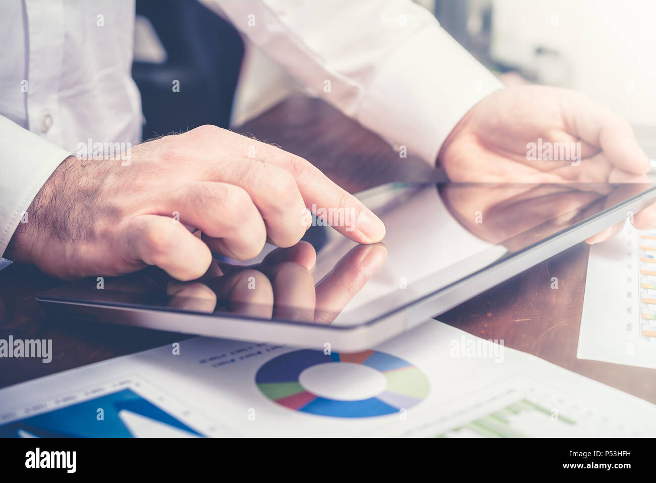 Businessman Analyzing Financial Statistics With Tablet Stock Photo