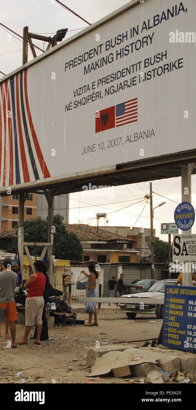 Poster commemorating the visit of President George Bush in Albania ( June 10, 2007). Posted in Albanian and English. Bus Station. Tirana. Albania. Stock Photo