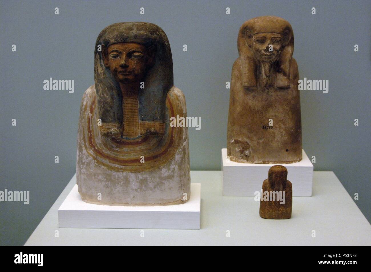 Busts of ancestors. First, polychromed limestone bust, from Thebes. At background, limestone bust of unknown origin. Both dated from 1300-1150 BC. On the right, and the smaller, wooden bust dated 1550-1070 BC, also of unknown origin. 19th and 20th Dynasties. New Kingdom. British Museum. London. United Kingdom. Stock Photo
