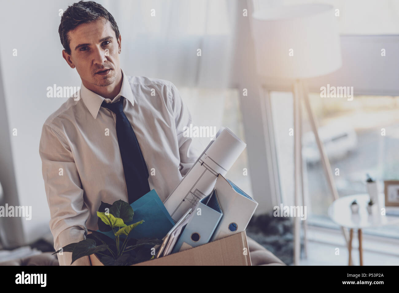 Cheerless young man leaving the office Stock Photo