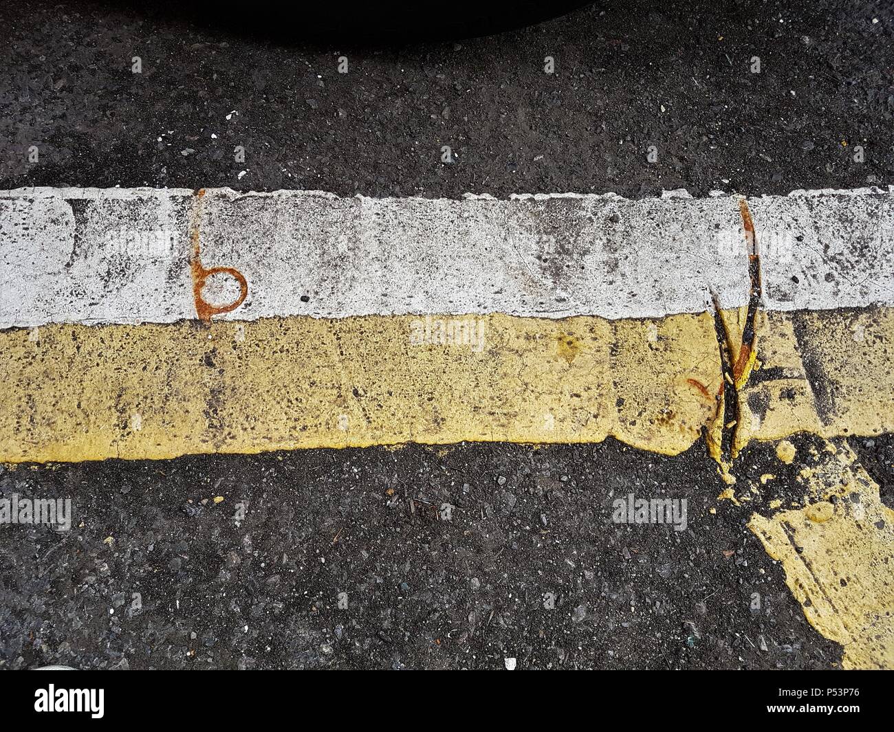 White and yellow road lines / markings on road Stock Photo