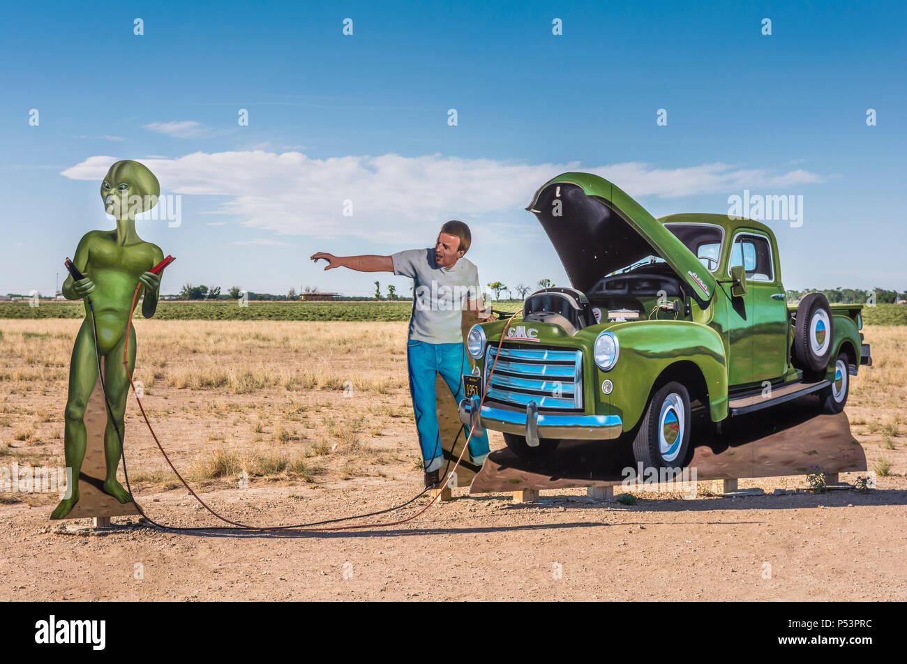 Roswell, New Mexico, USA, city limits a public art installation by John Cerney, depicts a local helping an alien jumpstart his flying saucer. Stock Photo