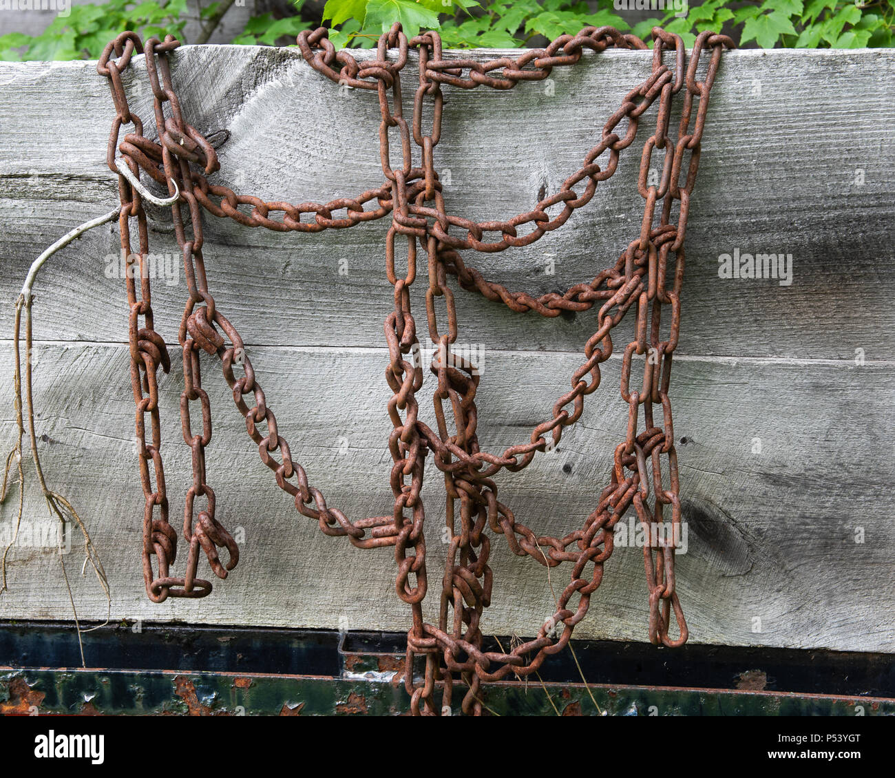 Old worn rusty tire chains for traction in snow and ice hanging on the