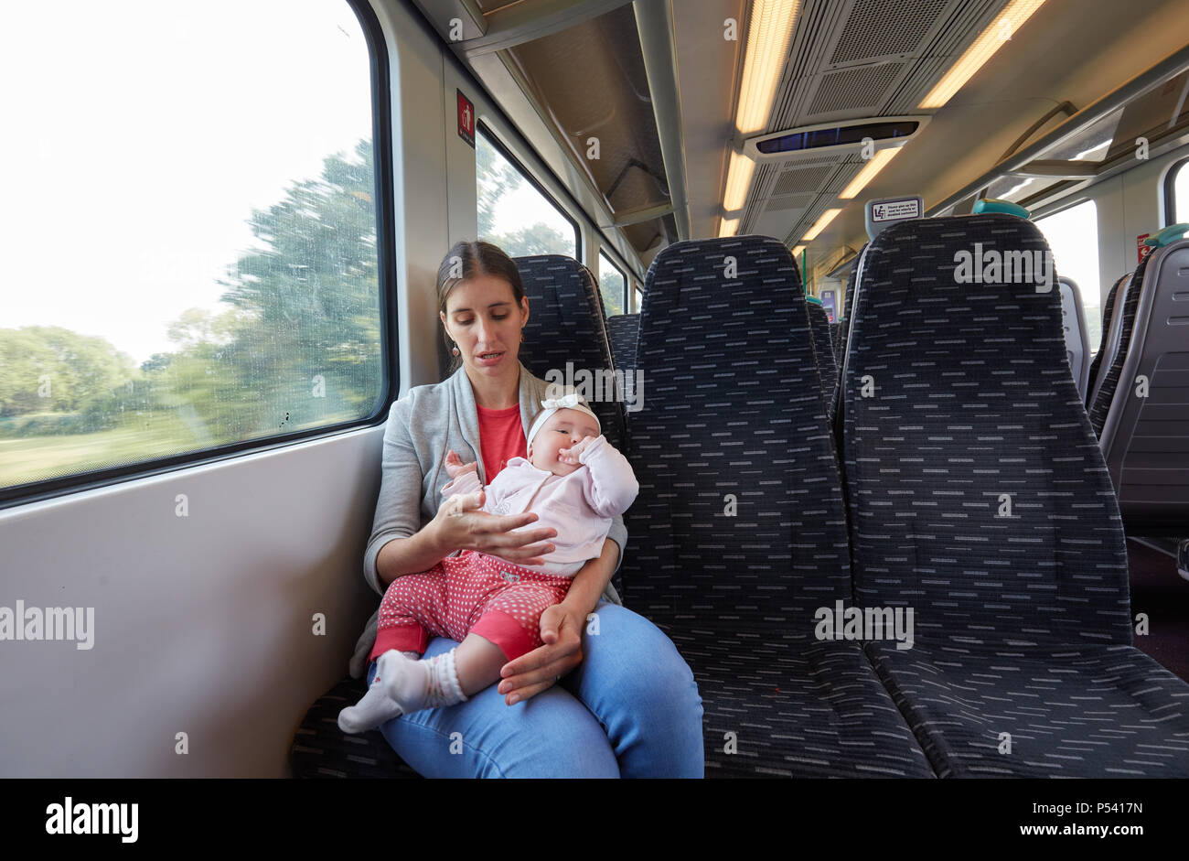 Young mother travelling with baby girl on the train Stock Photo Alamy