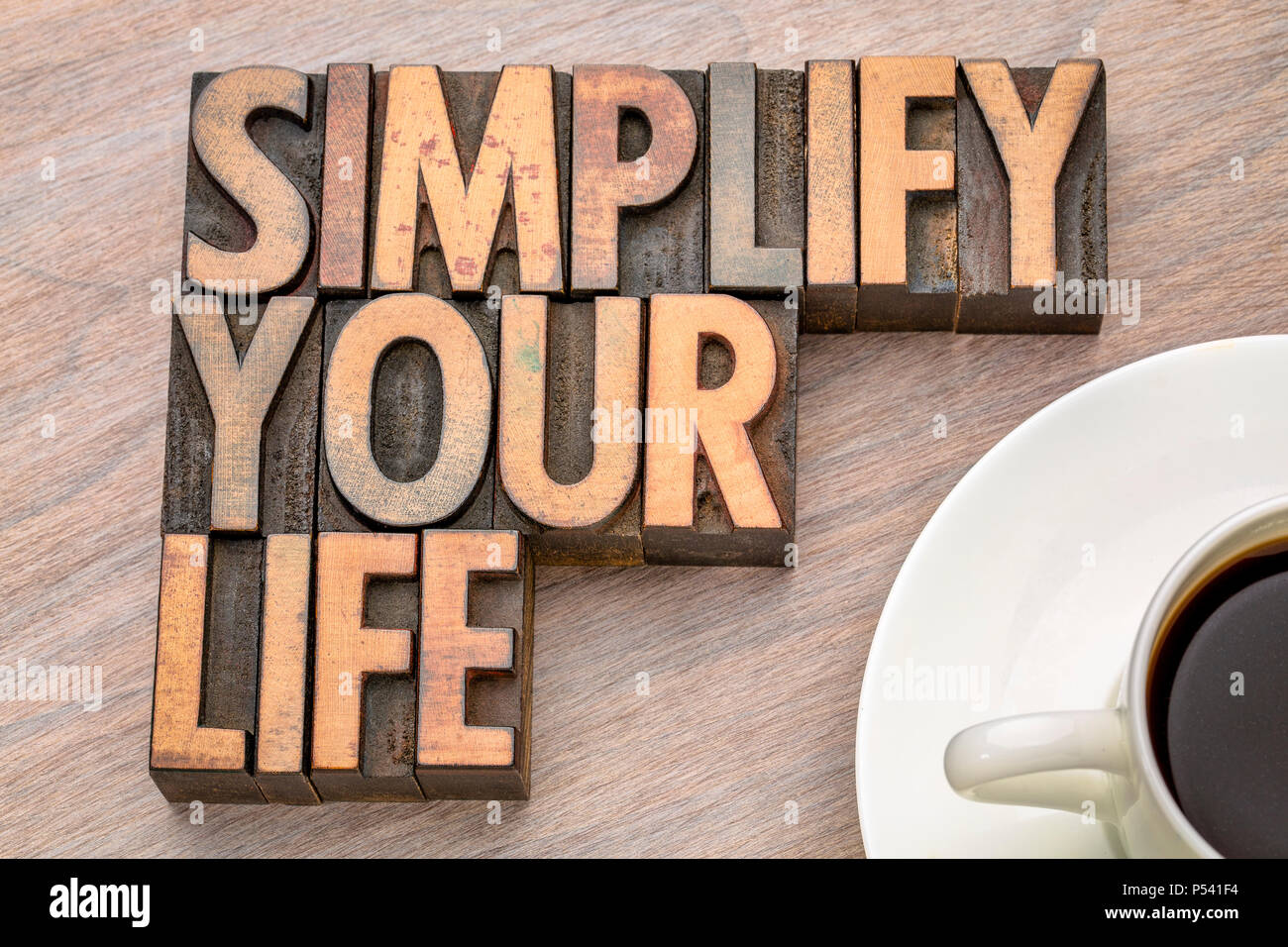 simplify your life advice - word abstract in vintage letterpress wood type with a cup of coffee Stock Photo