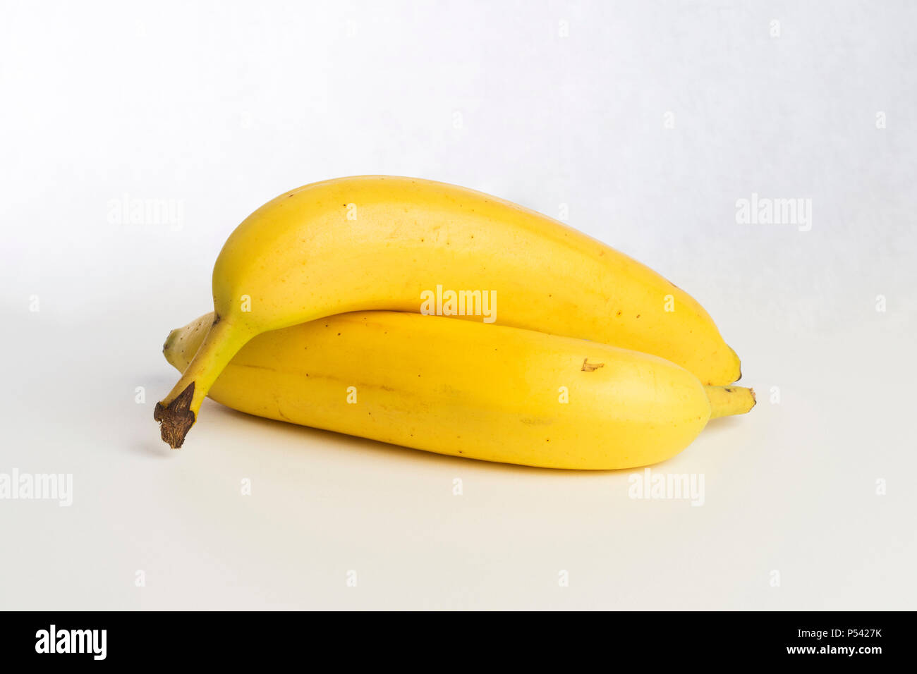 Yellow organic tasty bananas on white background. Good healthy raw food
