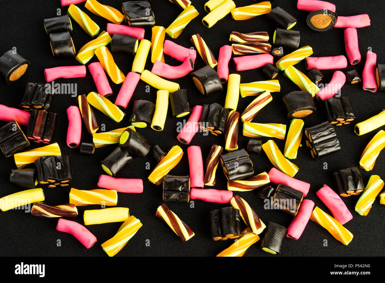 Details of colorful tasty sweet finish licorice candy on black