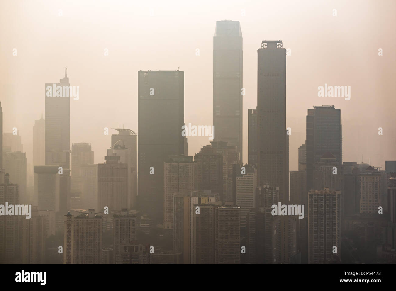 Big city skyline in smog with skyscrapers silouhettes Stock Photo