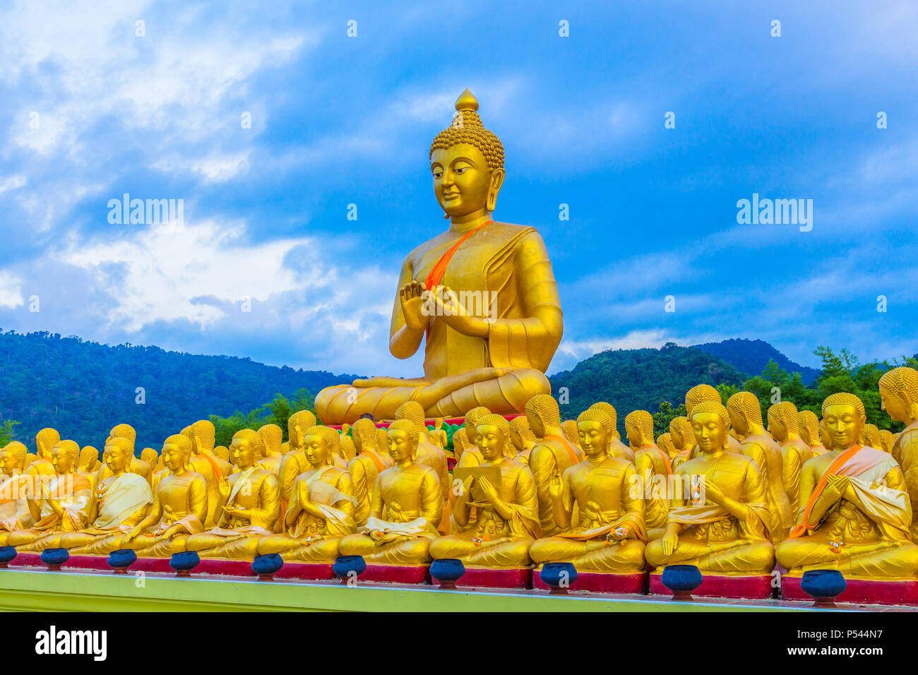 the golden big Buddha statue among a lot of small Buddha statues in