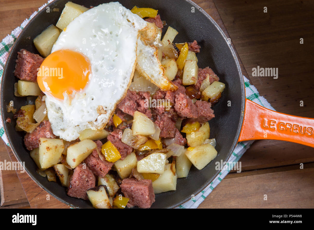 Freshly cooked Corned beef hash with a fried egg served in the pan