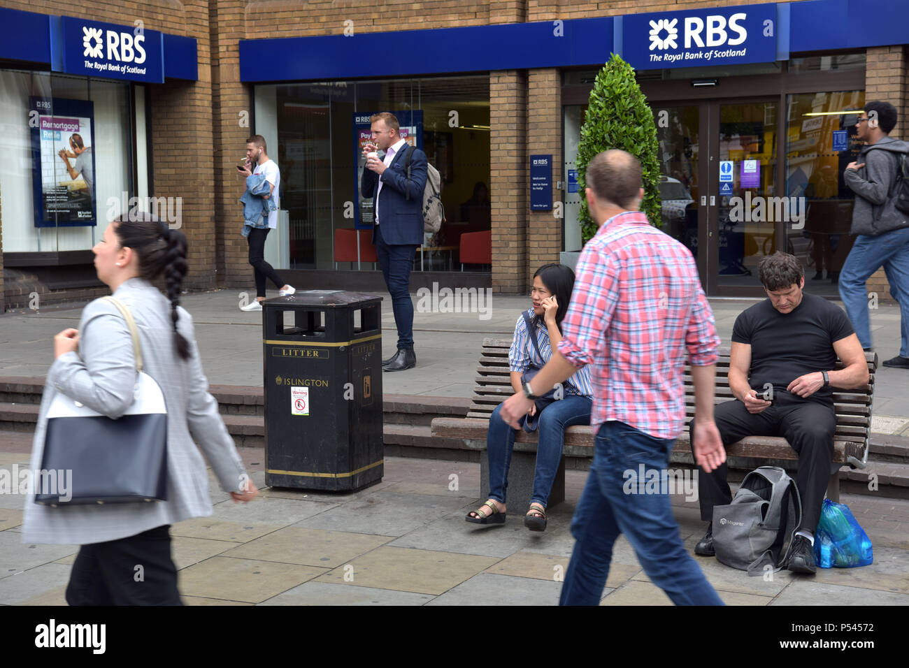 People walk past the branch of the Royal Bank of Scotland bank near the Angel, Islington, North London. Stock Photo