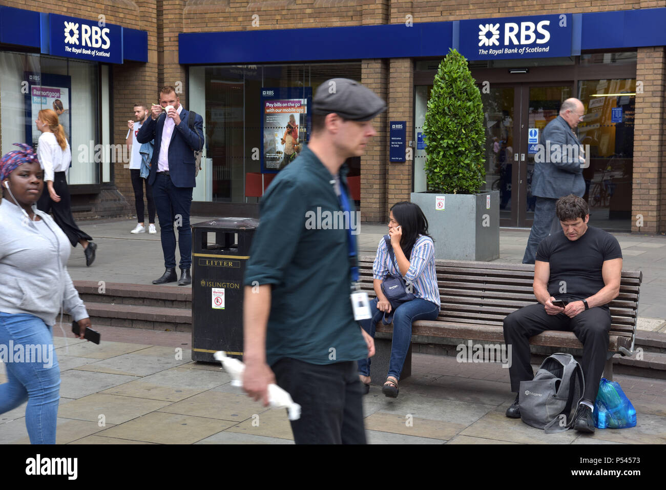 People walk past the branch of the Royal Bank of Scotland bank near the Angel, Islington, North London. Stock Photo
