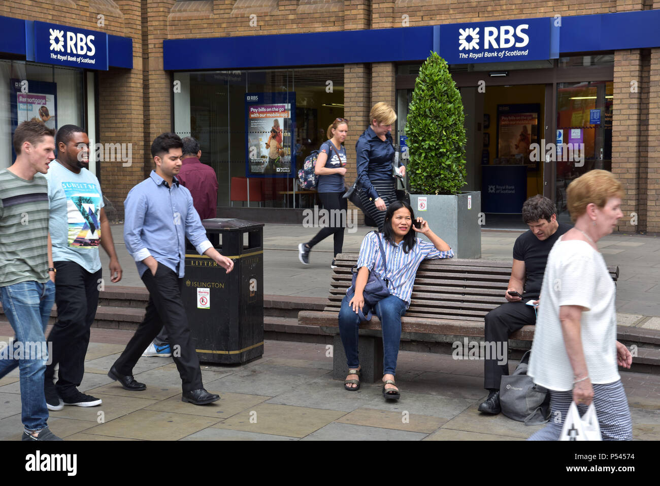 People walk past the branch of the Royal Bank of Scotland bank near the Angel, Islington, North London. Stock Photo