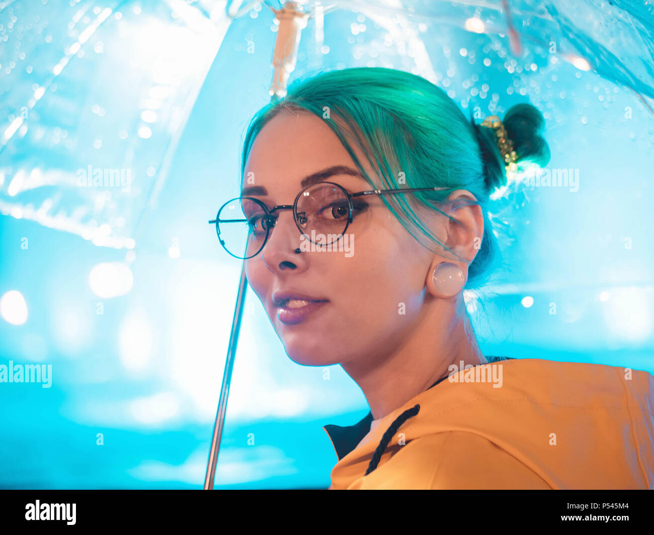 Young Pretty Girl With Blue Dyed Hair In Yellow Raincoat And With
