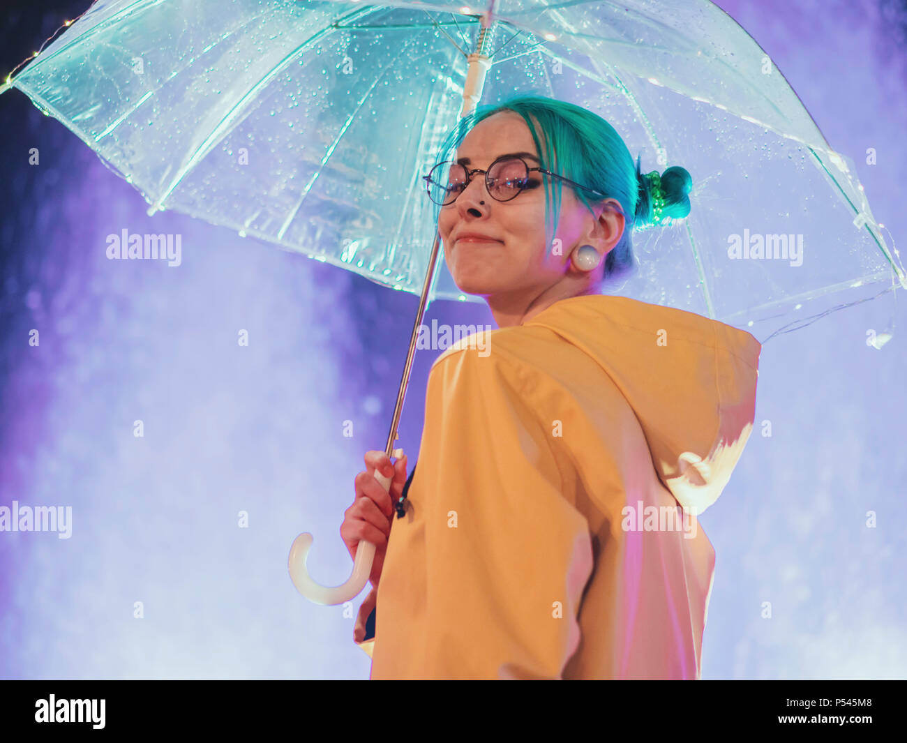 Young Pretty Girl With Blue Dyed Hair In Yellow Raincoat And With
