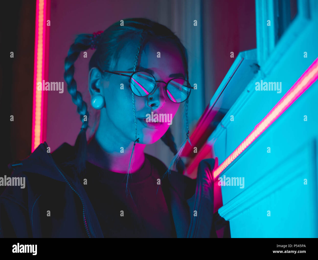 Young Pretty Girl With Unusual Hairstyle Near Glowing Pink And