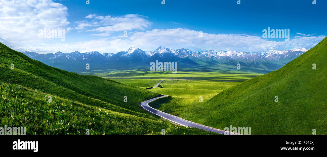 Road to snowy mountains in the morning,panoramic view Stock Photo