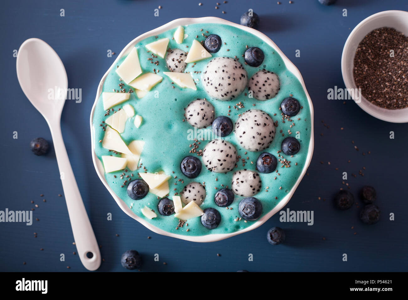 healthy blue spirulina smoothie bowl with blueberry, white chocolate
