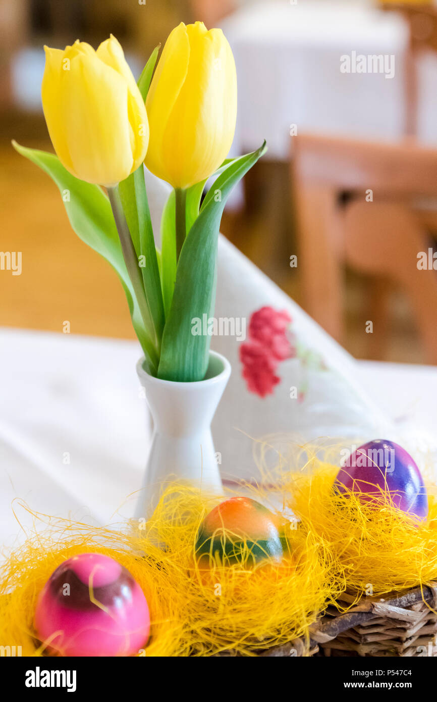 Three easter eggs on wicker basket with flowers Stock Photo - Alamy