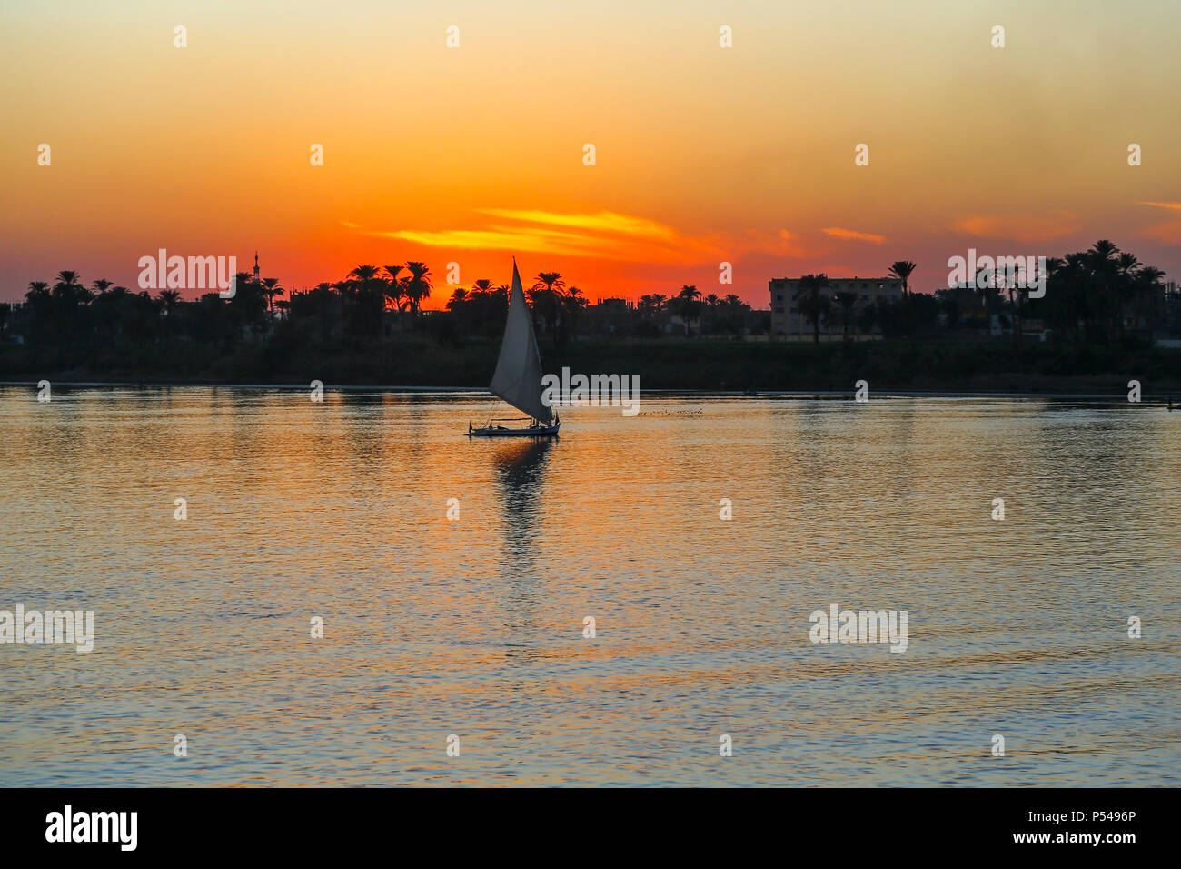 Sunset on the Nile River with Felucca boat sailing, Luxor, Egypt, Africa Stock Photo