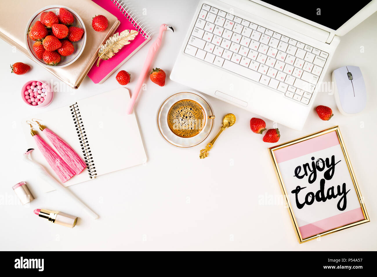 Trendy feminine home workplace. Home office desk with laptop, notebook