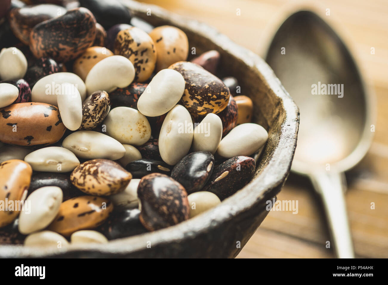 Colorful Raw Beans on Dark Wooden Background Stock Photo