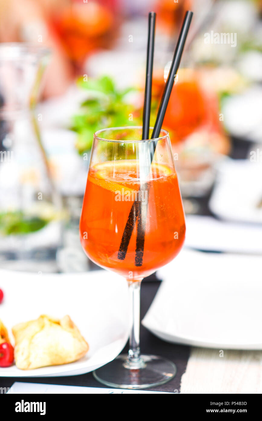 A orange drink in a glass of wine in the restaurant beautifully served. Stock Photo