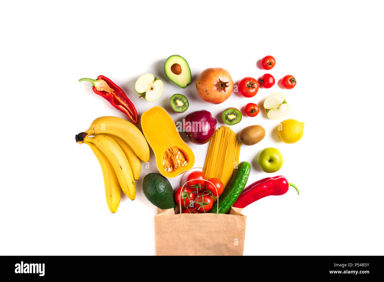 Healthy food background. Healthy food in paper bag pasta, vegetables and fruits on white. Shopping vegetarian food supermarket concept. Top view Stock Photo