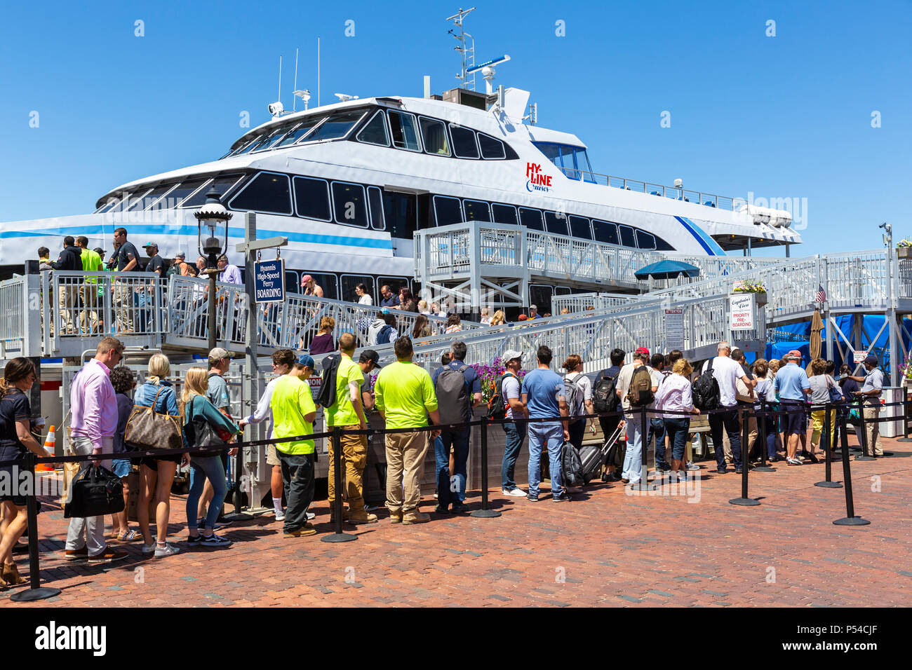 Passengers board a Hy-Line Cruises high-speed catamaran ferry, bound for Hyannis on the mainland, in Nantucket, Massachusetts. Stock Photo