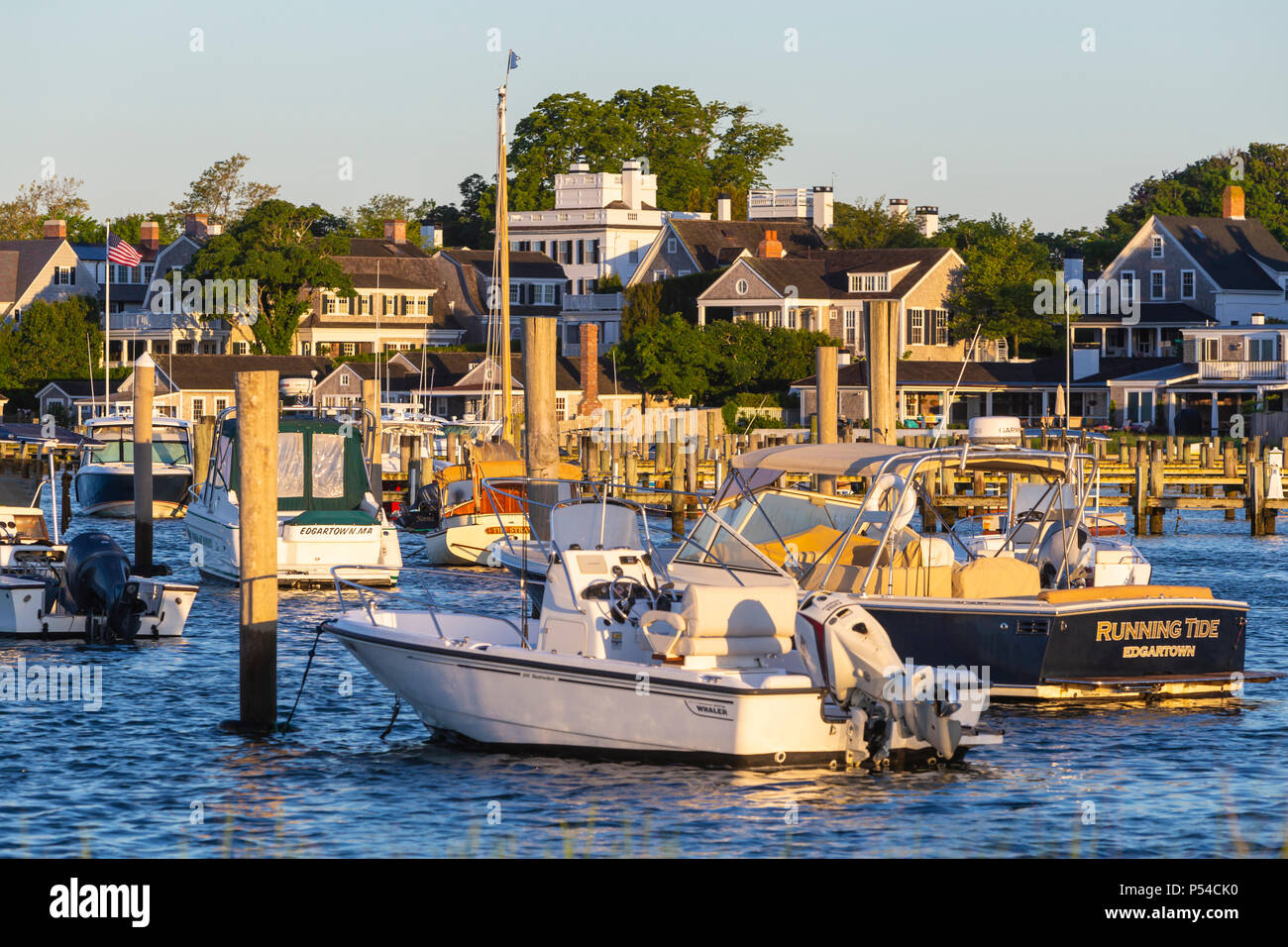 Boats moored and docked in the harbor, overlooked by stately sea captains' homes in Edgartown, Massachusetts on Martha's Vineyard. Stock Photo