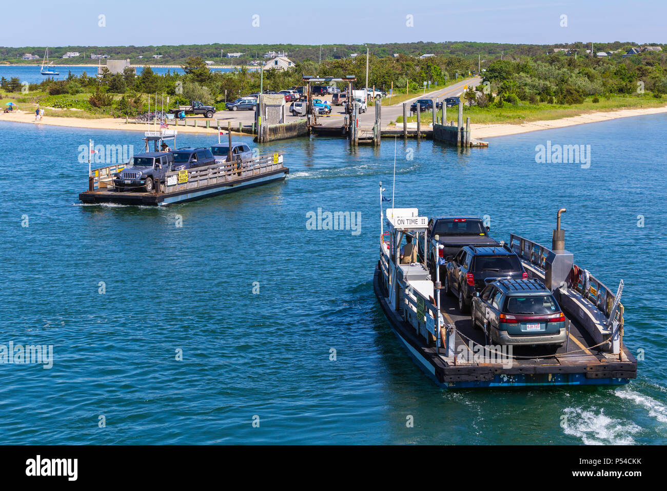 Two Chappy Ferries pass each other crossing the harbor between Chappaquiddick Island and downtown Edgartown, Massachusetts on Martha's Vineyard. Stock Photo