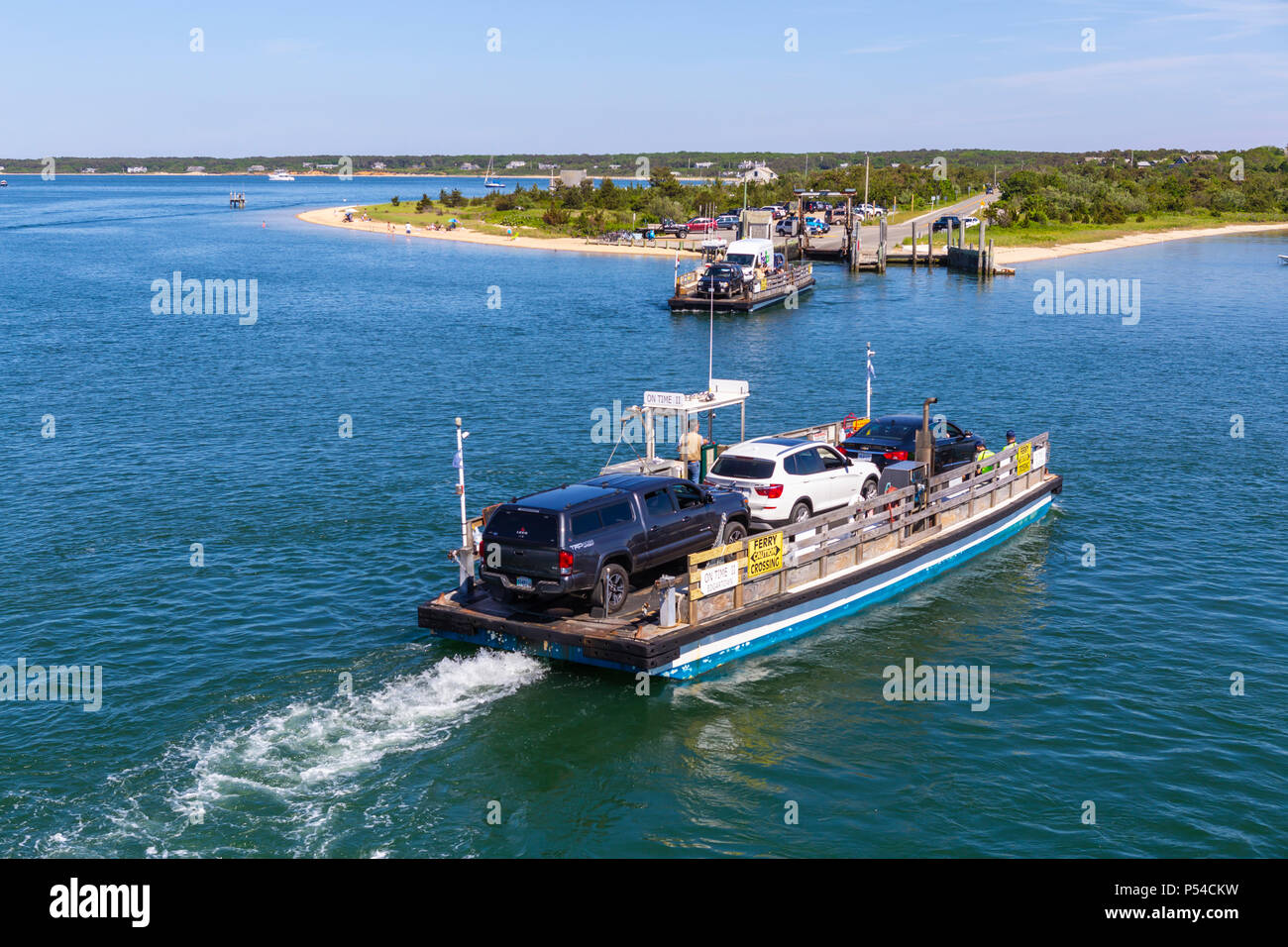 Two Chappy Ferries pass each other crossing the harbor between Chappaquiddick Island and downtown Edgartown, Massachusetts on Martha's Vineyard. Stock Photo