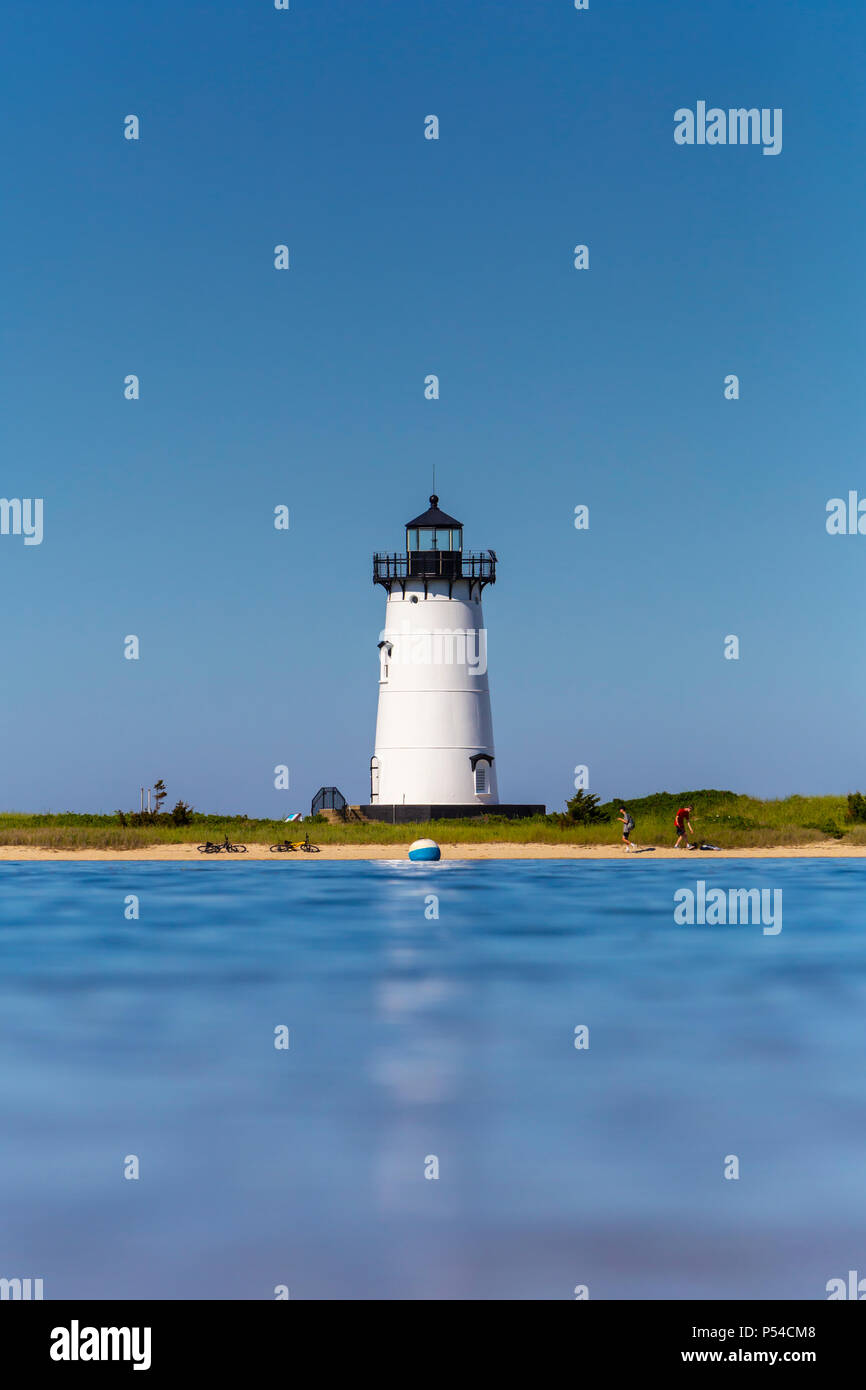 A water level view of Edgartown Harbor Light set against a clear blue sky in Edgartown, Massachusetts on Martha's Vineyard. Stock Photo