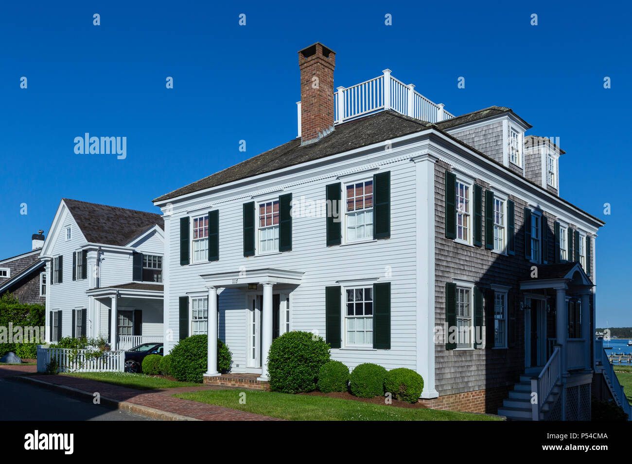 A white clapboard-fronted house, in the style of a sea captain's home, along N Water Street in Edgartown, Massachusetts on Martha's Vineyard. Stock Photo
