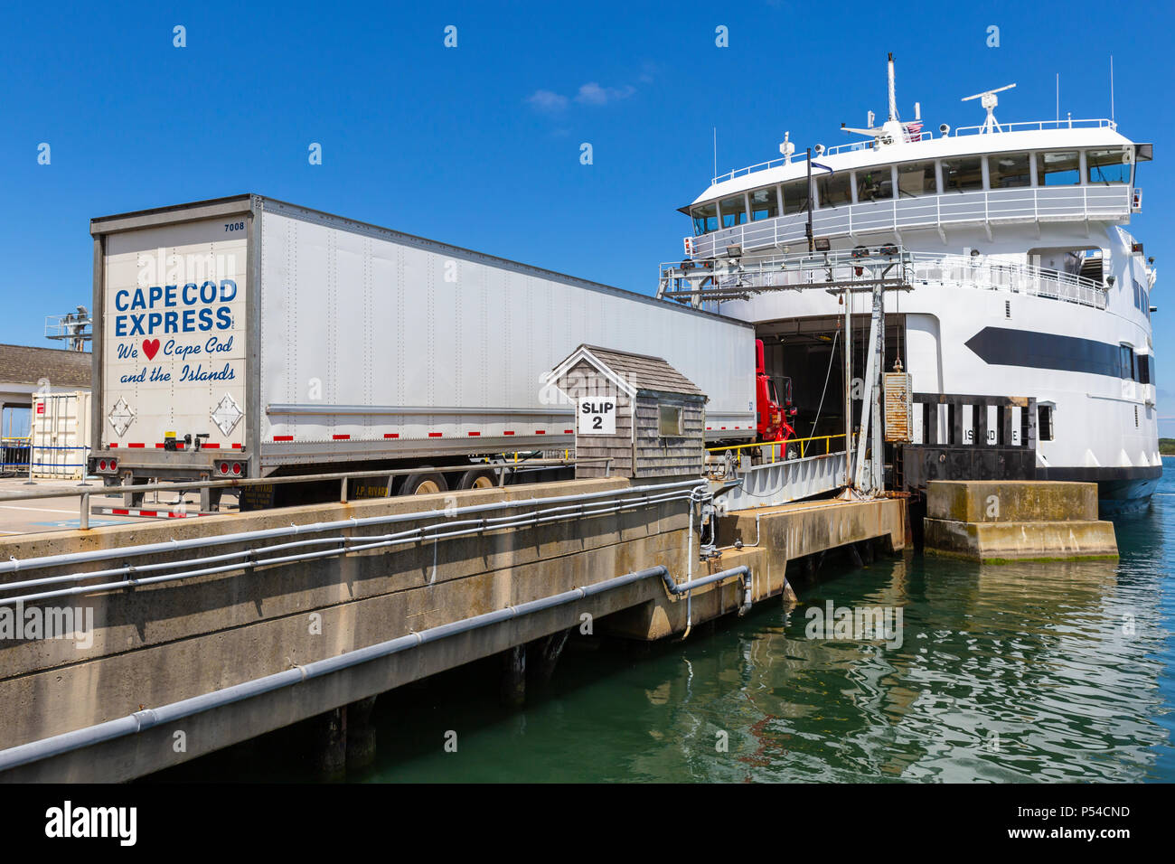 A Cape Cod Express semi-tractor trailer drives aboard a Steamship Authority ferry in Vineyard Haven on Martha's Vineyard, headed for the mainland. Stock Photo