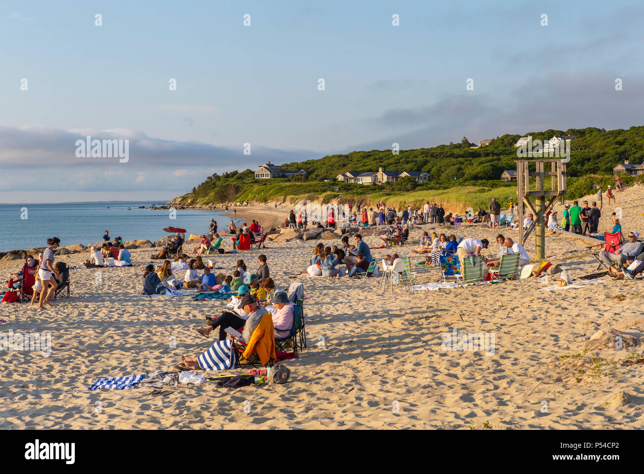 People gather and wait on Menemsha beach to view the sunset over the