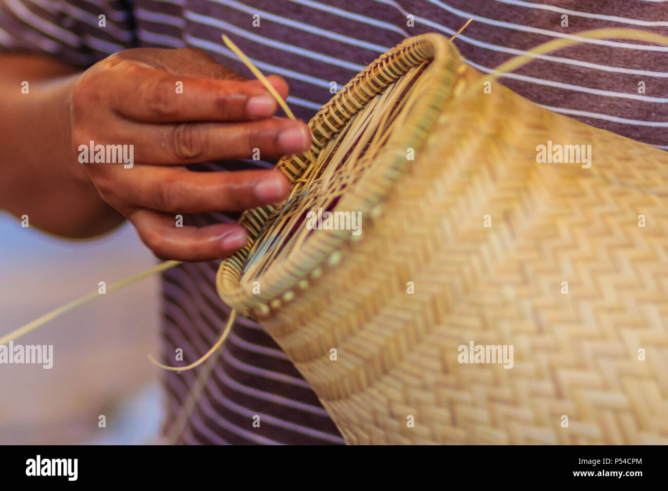 Close up hands weaving bamboo steamer in northeastern village of Thailand Stock Photo