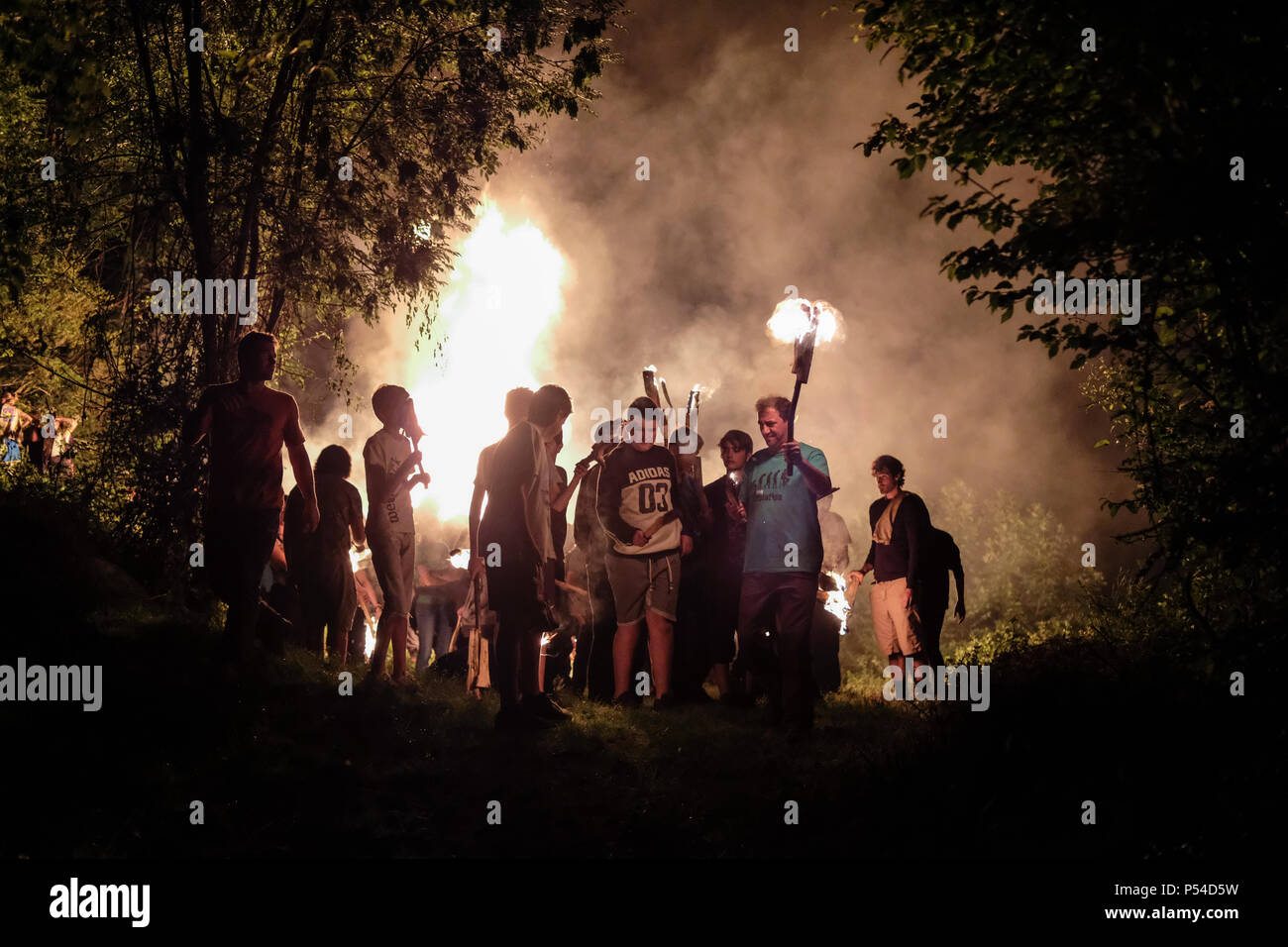 San Juan De Plan, Spain. 23rd June, 2018. Revelers celebrates San Juan Night in the small village in San Juan de Plan, Huesca, northern Spain. They light the bonfire on the mountain and descend with burning 'teas' once in the village they make a run up to the cemetery where another fire is made and the 'teas' are deposited. Feast recognized by UNESCO. Credit: Mikel Cia Da Riva/ Pacific Press/Alamy Live News Stock Photo