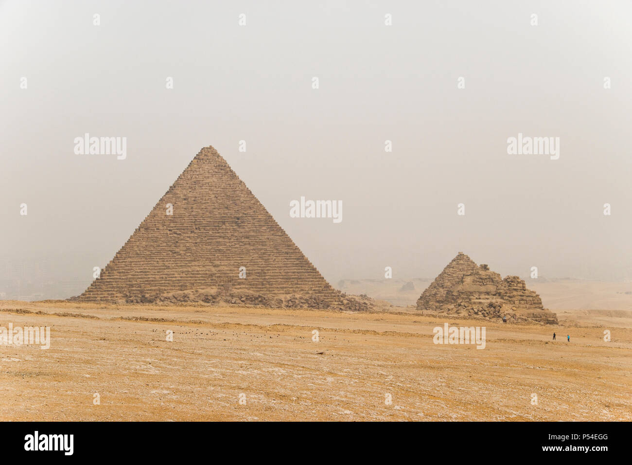 The Menkaure Pyramid (left), and the three small “queen’s pyramids” at Giza, Egypt. Stock Photo