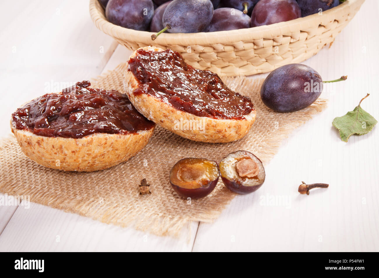 Sandwiches with plum marmalade or jam on jute burlap, concept of delicious breakfast Stock Photo