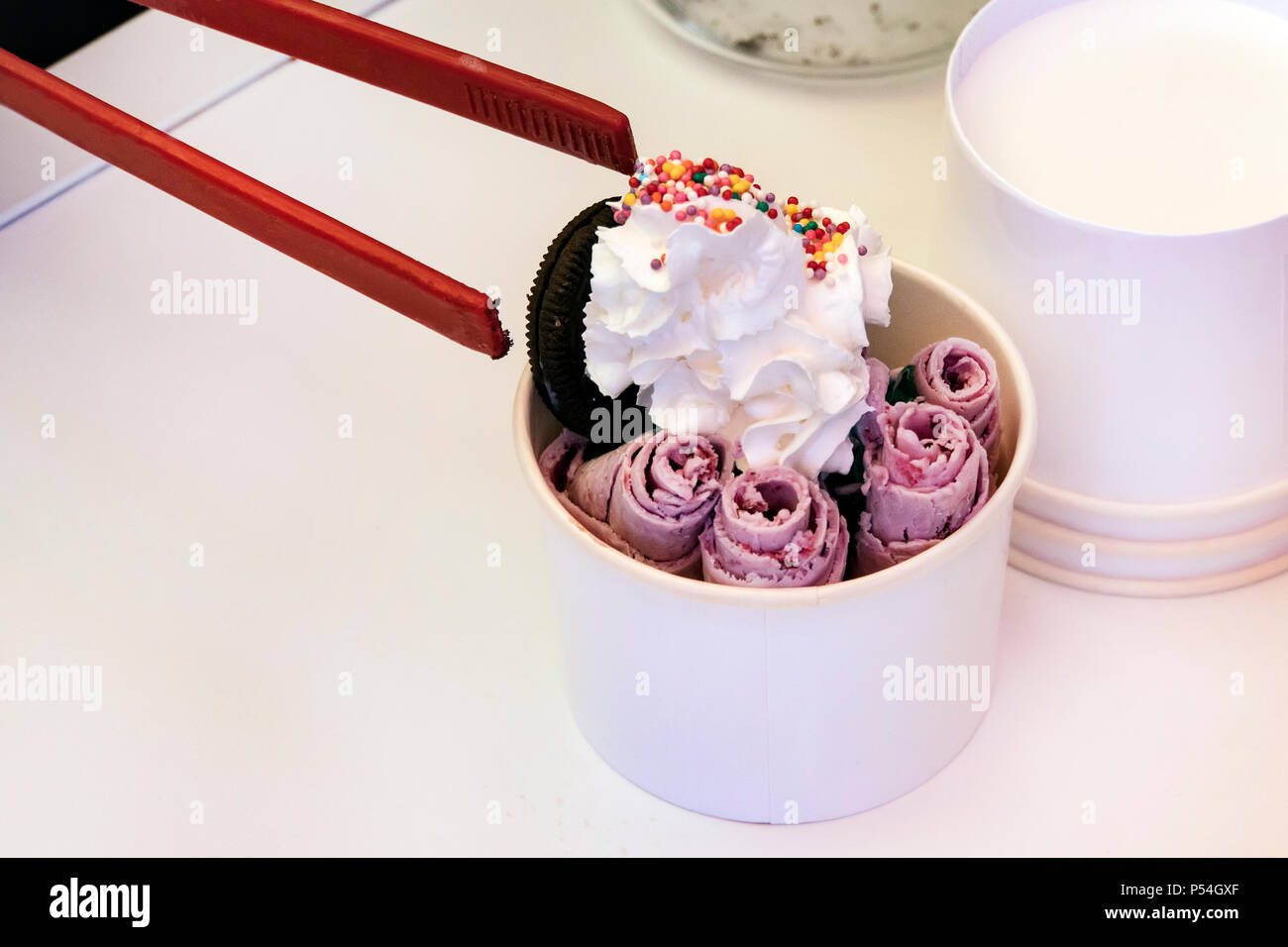 https://c8.alamy.com/comp/P54GXF/stir-fried-ice-cream-rolls-at-freeze-pan-rolled-ice-cream-hand-made-ice-cream-dessert-fried-ice-cream-machine-with-steel-chilled-pan-cooking-proce-P54GXF.jpg