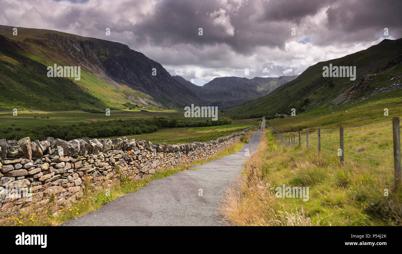 Road through Nant Ffrancon valley, Snowdonia, North Wales under stormy skies Stock Photo