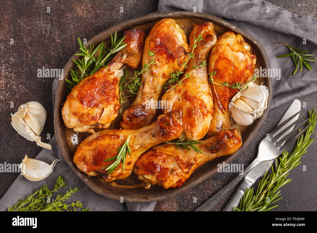 Grilled spicy chicken legs baked with garlic, rosemary and thyme on