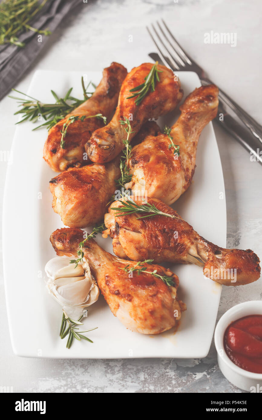 Grilled spicy chicken legs baked with garlic, rosemary and thyme in